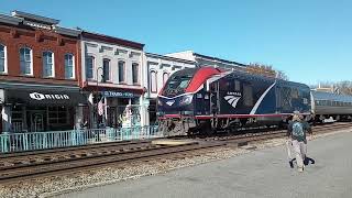 Amtrak 328 leads a passenger train through a small town