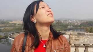 Junjun on top of a Diaolou in Zili village, Kaiping, China