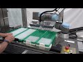 ur5 collaborative robot loading parts onto a conveyor