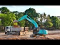 kobelco sx200 excavator operator skillfully processing the best project loading double dump truck.