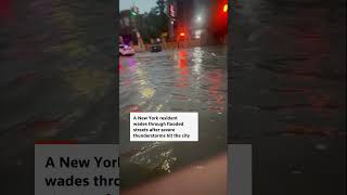 New Yorker wades through flooded streets after thunderstorms