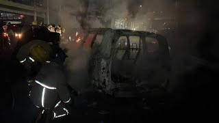 Rescuers extinguish fire in car as Hezbollah supporters block airport road | AFP