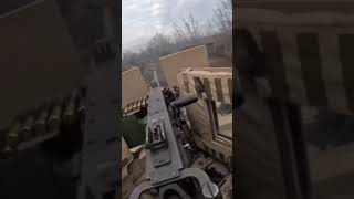 Ukrainian machine gunner of an American MRAP MaxxPro fires at Russian positions in Avdiivka