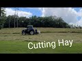 Cutting Hay with a Kuhn Mower and New Holland Powerstar 75 Tractor