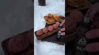 Snow on the grill, FYR BLK Sauce on the smash veal burgers—turning winter into a flavor wonderland!