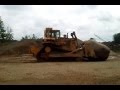 Cat D9N Pushing Big Rock