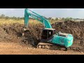 best kobelco sk 200 excavator diggings mud for new road អេស្កាវ៉ាទ័រកាយភក់ចេញដើម្បីធ្វើគ្រឺសផ្លូវ