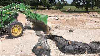 Building a rubble trench foundation and laying the first seven courses of CEBs on a home build