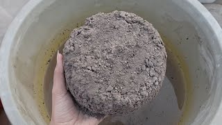 Black gritty charcoal shapes crumbling in water oddly satisfying