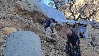 Iran nomadic life: building shelter walls with stone and dirt to prevent winter cold