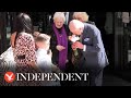 King and Queen exchange flowers and gifts with children as Charles resumes public duties