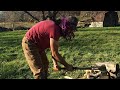 Splitting firewood by using a splitting maul.