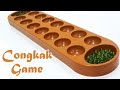 Playing Congkak Games - Malaysia Traditional Games