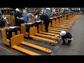 Process of Making an Electric Fork Pallet Truck. Logistics Equipment Factory in Korea.