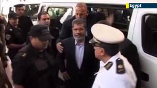 Jailed ex-Egyptian President Mohammed Morsi dons convict uniform and smiles in prison mugshot