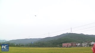Helicopter carries electric linemen to work on super high voltage transmission lines