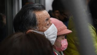 Japan eases mask guidelines but few keen to change | AFP