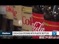 Business report: Coca-Cola sticking with plastic bottles