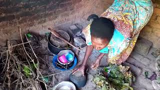 life in African village homes, cooking green vegetables for the meal ..