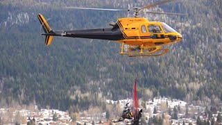 Eurocopter AS-350 with snowmobile sling load.