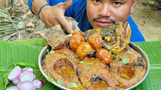 EATING  FISH CURRY WITH  GREEN  CHILLI