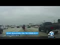 ONLY IN L.A.: Man with headphones strolling in lanes of 110 Fwy during morning rush hour I ABC7