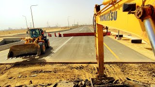 excavator removing asphalt