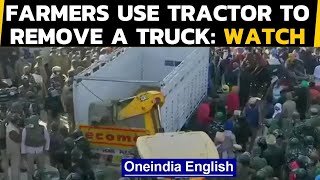 Farmers clashed with forces at Tikri border, removed a truck with a tractor: Watch|Oneindia News