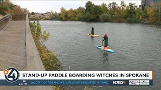 Three sisters dressed as ‘Sanderson Sisters’ paddle board on the Spokane River for Halloween