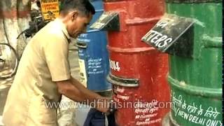 Indian Postman empties a letter box - archival footage of the daakiya