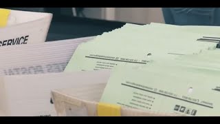 Postmaster general says he will suspend USPS changes until after election