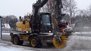 Volvo EW140C sweeping snow