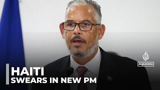 Haiti swears in new PM as gunfire at airport hits flight from US