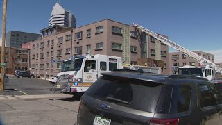 Firefighters used ladders to rescue several people stuck on the roof of burning apartment building