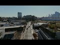 aerial view of a street with cars driving by in williamsburg brooklyn. modern buildings stand on