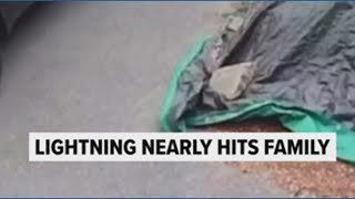 Caught on camera: Lightning strike barely misses family