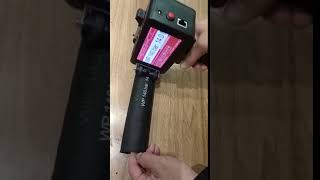 Handheld Inkjet printer coding machine printing on Automobile tubing with white ink.