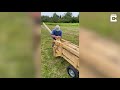 farmer uses homemade hay baler