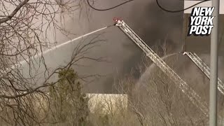 Firefighters battle inferno after reported explosion near Texas airport, 7 injured