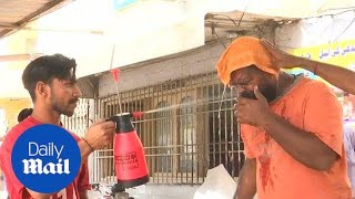 People in Karachi try to keep cool as city hit by heatwave