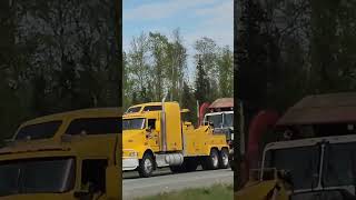 elete towing semi wrecker towing a garbage truck
