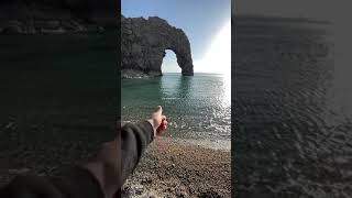 Flicking stones at Durdle Door