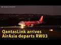 QantasLink (VH-NHY) arrives and AirAsia Indonesia (PK-AZK) departs RW03 at Perth Airport.