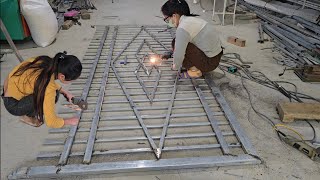 Two sisters were making an unfinished iron gate when they had to