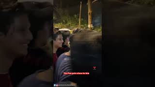 A "Fan" grabs Aryan Khan on shoulders