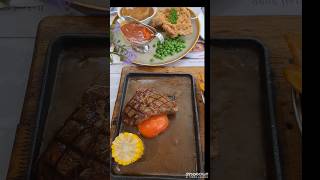 Steak with gravy , chicken chop with mashed potatoes,  salad and  potato wedges and scones .