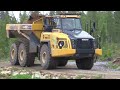 volvo ec300el loading a komatsu hm400 with overburden in a quarry