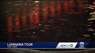 Families check out luminarias despite rain