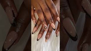 Almond shaped, black french nails with art