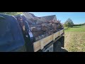 c5 mfg. flatbed dumping firewood.